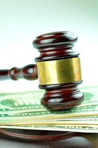 Auction concept with gavel on money background